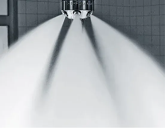 Water mist fire suppression nozzles in a marine space