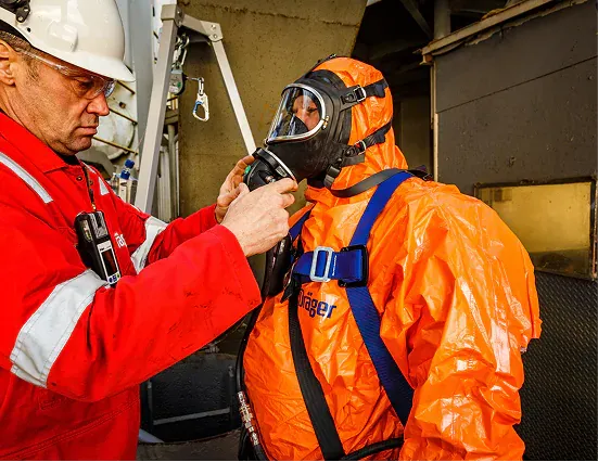Crew member checking a protective immersion suit