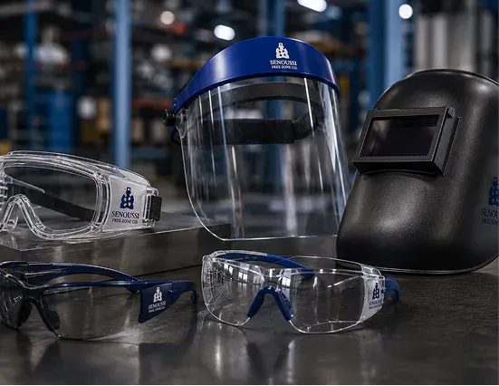 Worker wearing a welding visor and eye protection